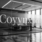Person researching the coyyn.com website on a laptop at a desk